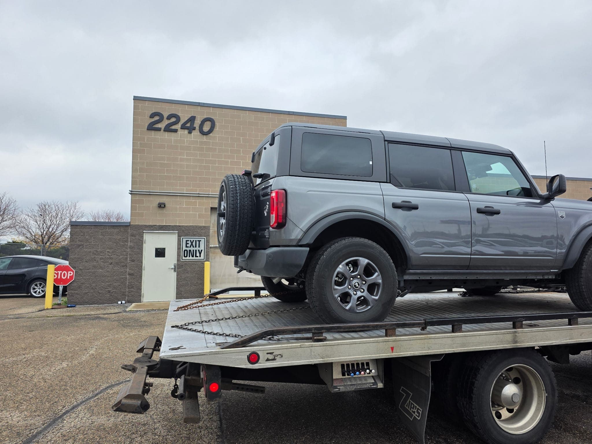 Pickup truck secured on a flatbed tow truck during local towing service in St Paul